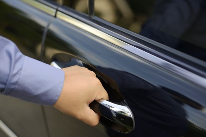 Man hand on handle and can't open car doors